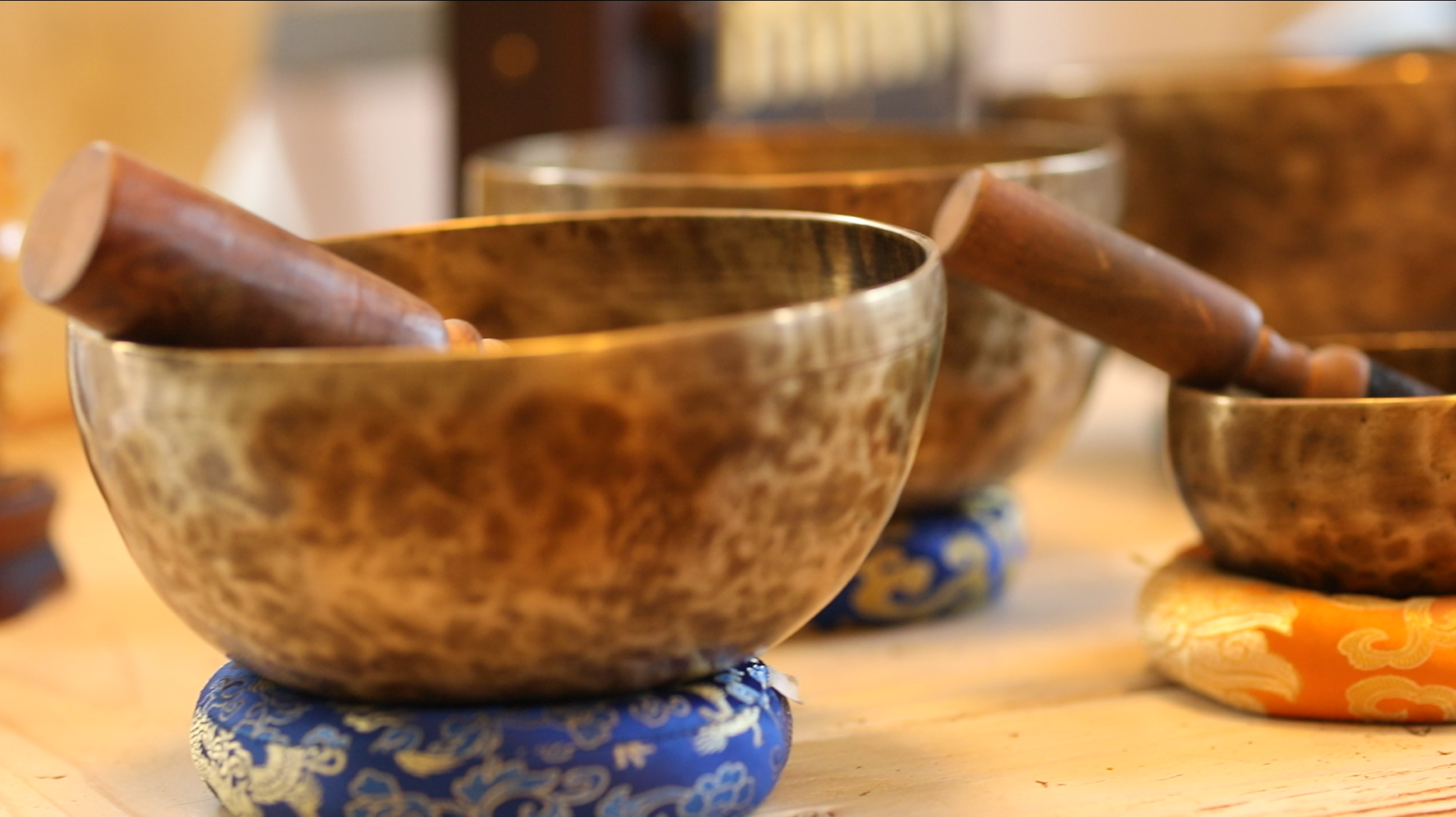 Tibetan singing bowl with wooden mallet in warm natural light